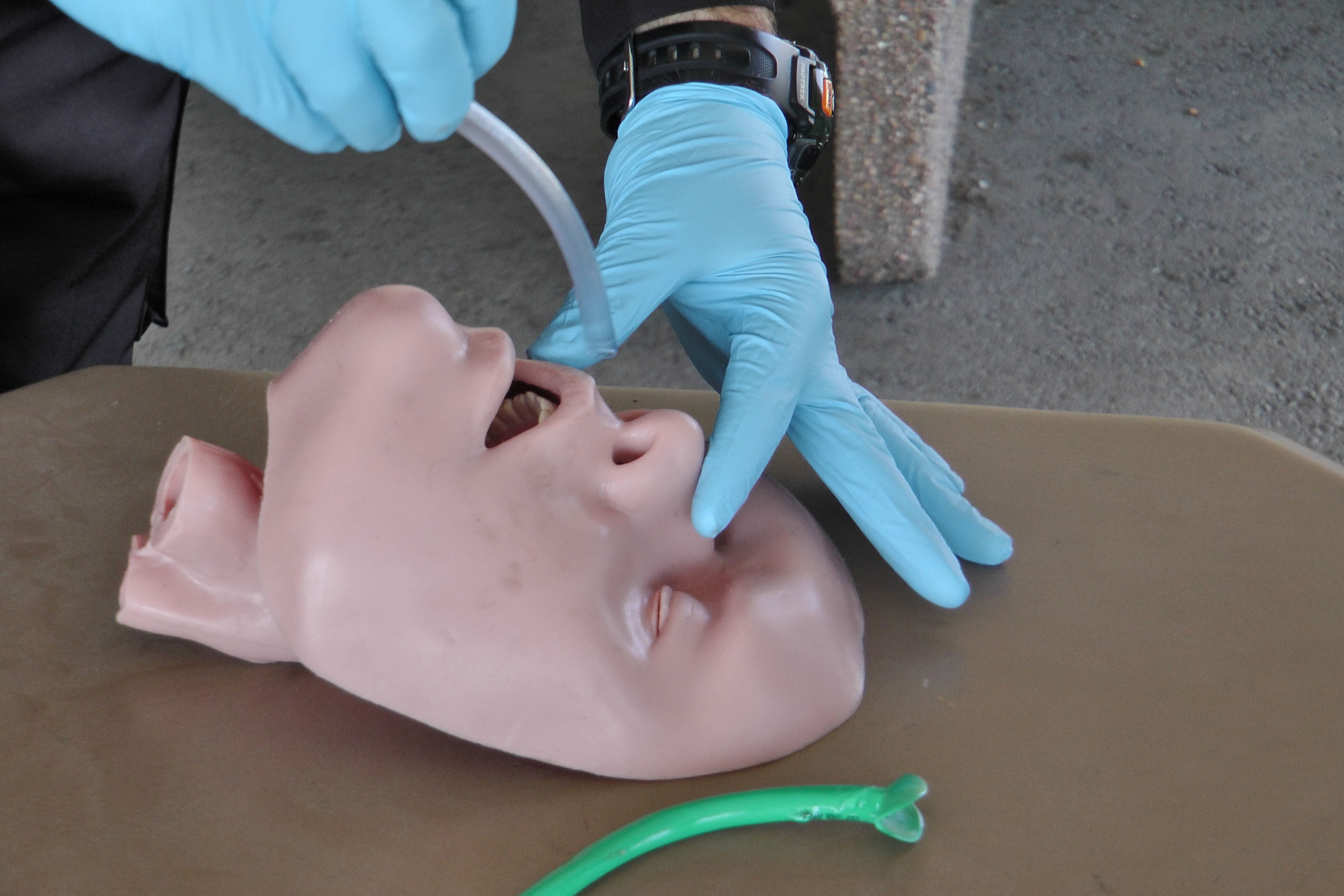 As a student, Jim had to learn combat first aid, like this photo where a nasopharyngeal airway (NPA) is inserted in the nose of a "gunshot victim."